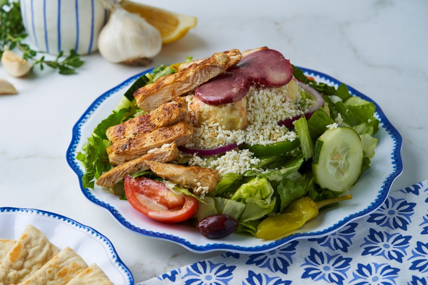 Fresh Greek salad with feta cheese, kalamata olives and vegetables at Little Greek Fresh Grill Winter Garden FL