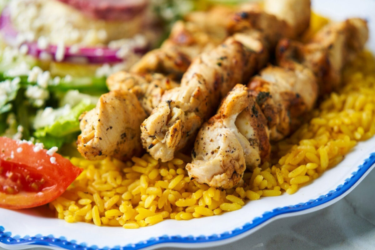 Chicken souvlaki skewers char-grilled and plated at Little Greek Fresh Grill Winter Garden FL inside Winter Garden Village